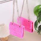 Hot pink sherpa Teddy Wallet Set in A6 and A7 sizes hanging by silver chain straps showing the soft fluffy texture