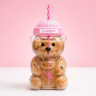main shot — clear teddy bear cup with iced coffee, pink lid, pink striped straw, LoveBaddie label, pink background): "Baddies & Budgets 20oz teddy bear glass cup filled with iced coffee, pink quilted lid, pink striped straw, on white surface with pink background